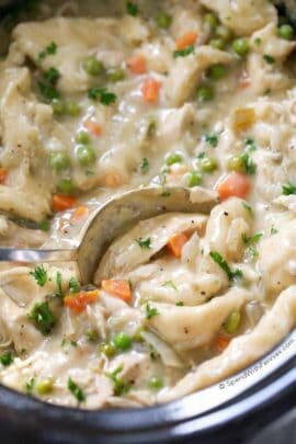 Crock Pot Chicken and Dumplings in the slow cooker with a spoon