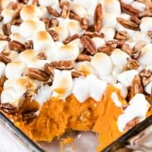 Sweet potato casserole in a dish with a serving scooped out