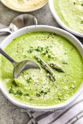 Asparagus Soup in a white bowl with a spoon