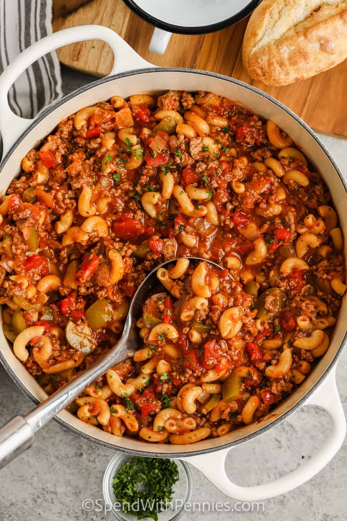 pot full of American Goulash with a spoon