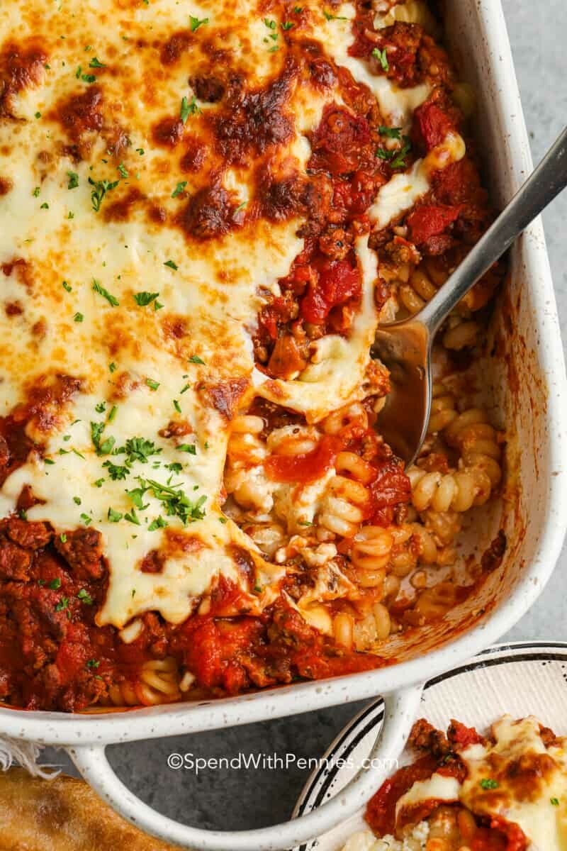 baked ground beef casserole in a dish with a spoon