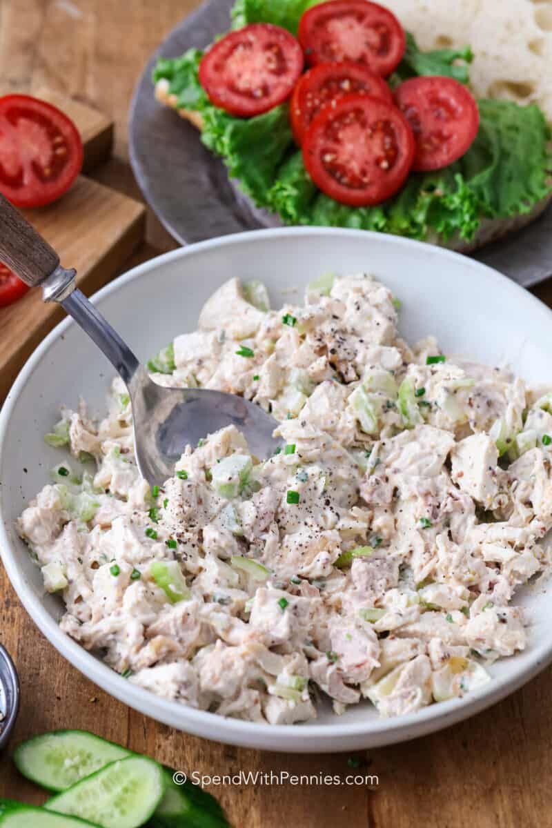 a bowl of mixed chicken salad with a spoon