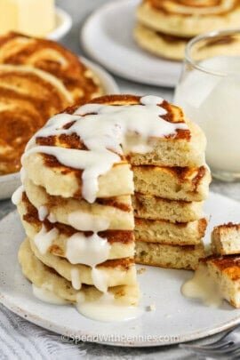 Cinnamon Roll Pancakes with a part taken out to show the inside