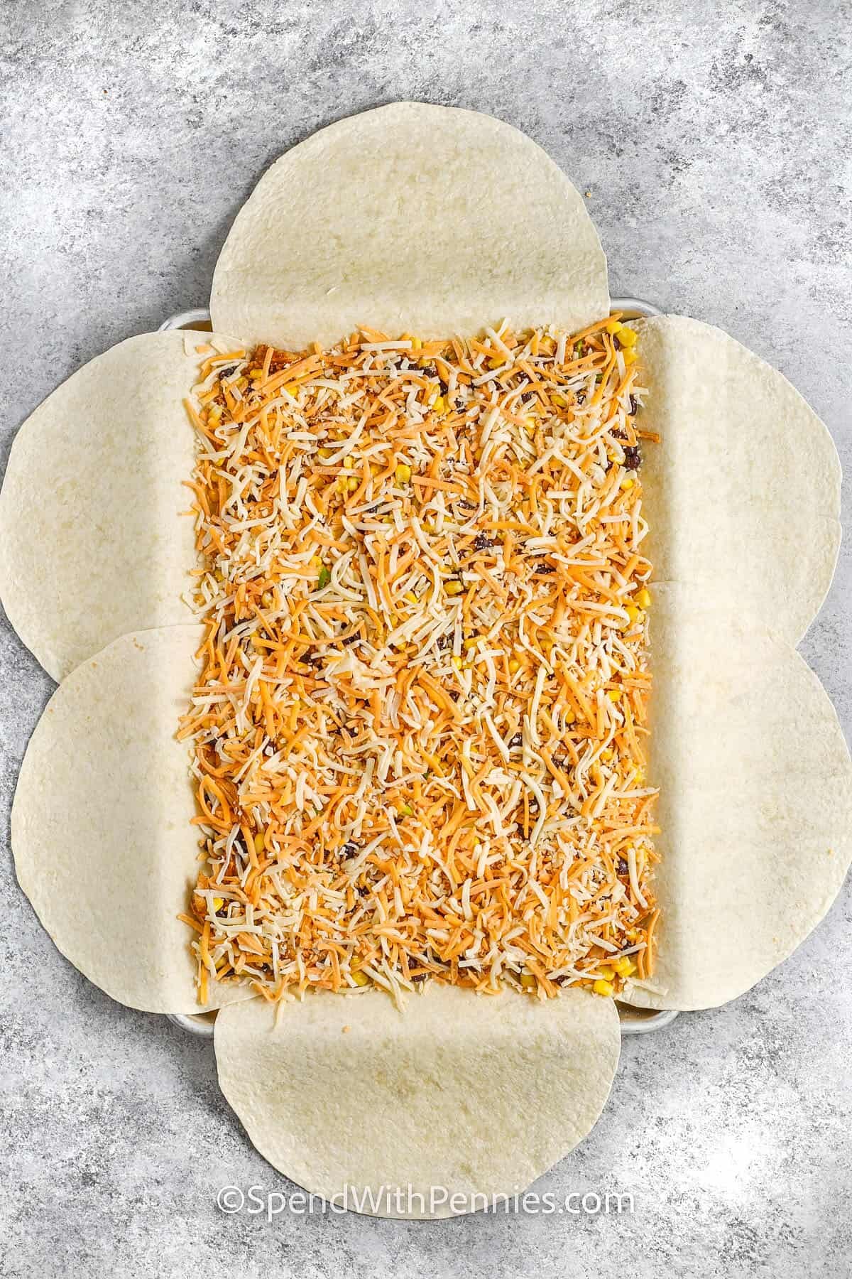 adding cheese to Sheet Pan Quesadillas